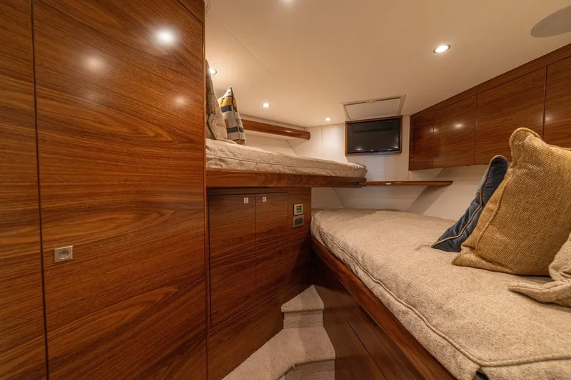 Game On Yacht Photos Pics Luxurious cabin interior of 2025 Viking 58 Convertible yacht with wooden finishes.