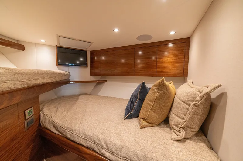 Game On Yacht Photos Pics Luxurious cabin interior of 2025 Viking 58 Convertible yacht with cozy bedding and modern design.