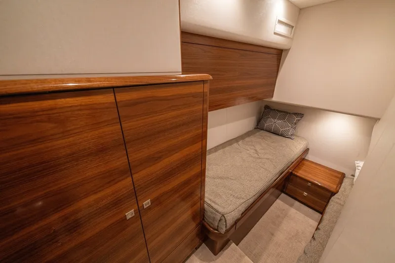 Game On Yacht Photos Pics Luxurious cabin interior of 2025 Viking 58 Convertible yacht with wooden finishes.