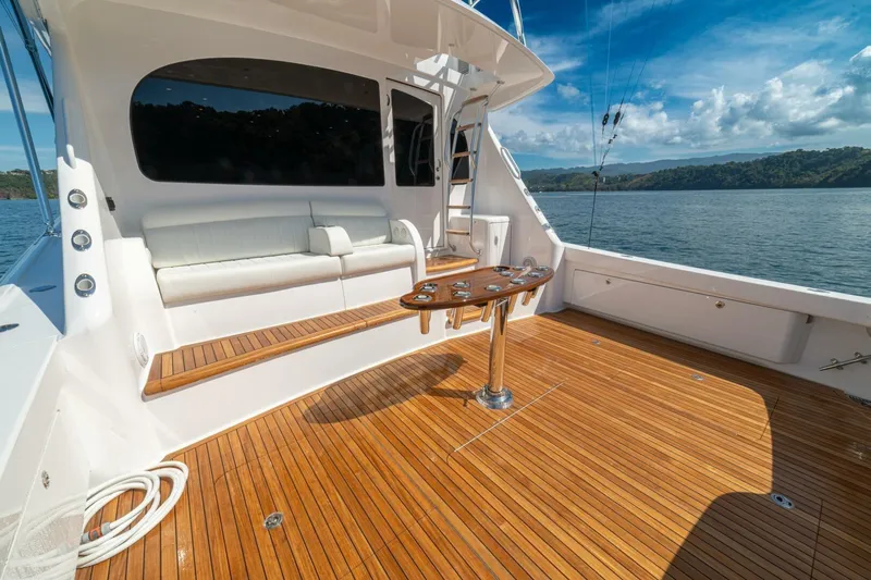 Game On Yacht Photos Pics Luxurious 2025 Viking 58 Convertible yacht deck with seating, wooden flooring, and ocean view.