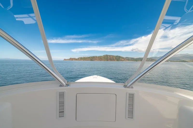 Game On Yacht Photos Pics View from 2025 Viking 58 Convertible yacht, overlooking ocean and distant coastline.