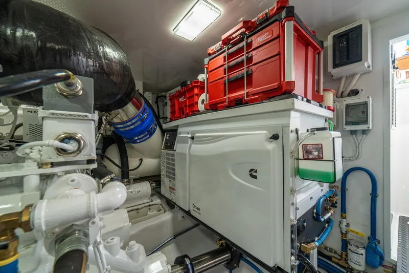 Game On Yacht Photos Pics Engine room of 2025 Viking 58 Convertible yacht with Cummins generator and tool storage.