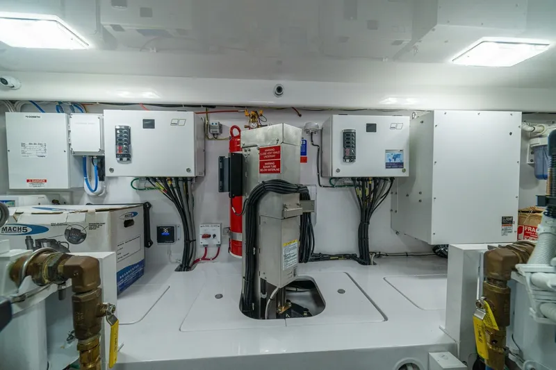 Game On Yacht Photos Pics Engine room of 2025 Viking 58 Convertible yacht with electrical panels and fire extinguisher.