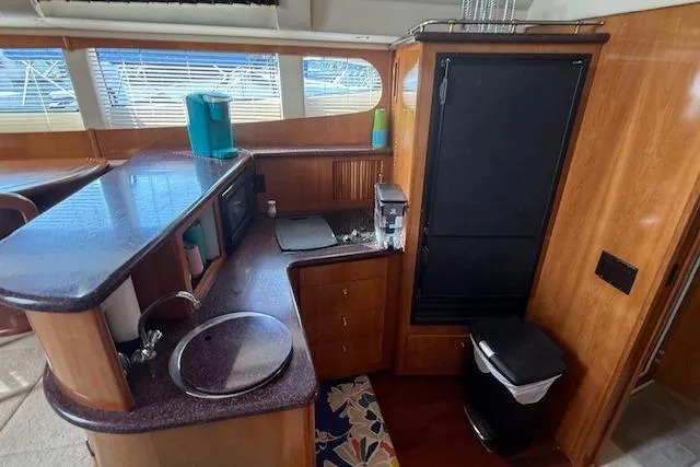  Yacht Photos Pics Interior of 2001 Carver 396 Aft Cabin Motor Yacht with kitchenette and wood finish.