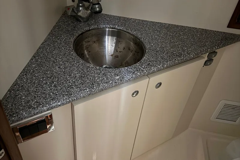 Chasin Tail Yacht Photos Pics 2011 Luhrs 30 Open boat bathroom with granite countertop and stainless steel sink.
