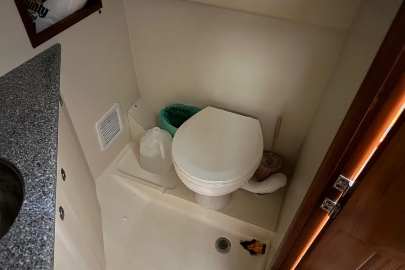 Chasin Tail Yacht Photos Pics 2011 Luhrs 30 Open boat bathroom with toilet, sink, and storage.