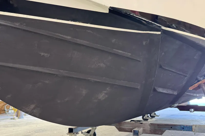 Chasin Tail Yacht Photos Pics 2011 Luhrs 30 Open boat hull in a workshop setting.