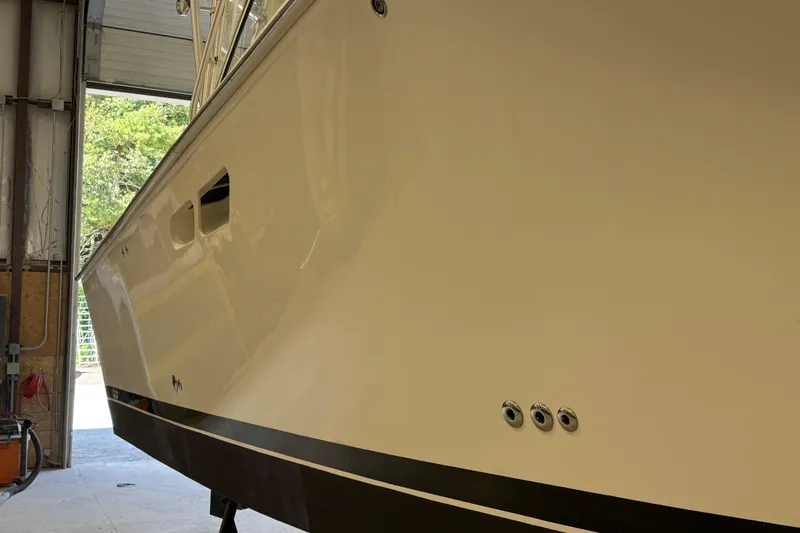 Chasin Tail Yacht Photos Pics 2011 Luhrs 30 Open boat in a garage, side view showing hull details.