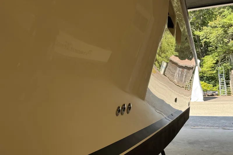 Chasin Tail Yacht Photos Pics 2011 Luhrs 30 Open boat hull reflecting outdoor scenery.