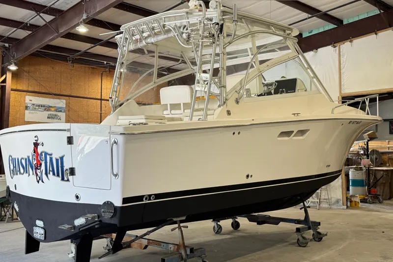 Chasin Tail Yacht Photos Pics 2011 Luhrs 30 Open boat in a workshop, featuring sleek design and sturdy build.