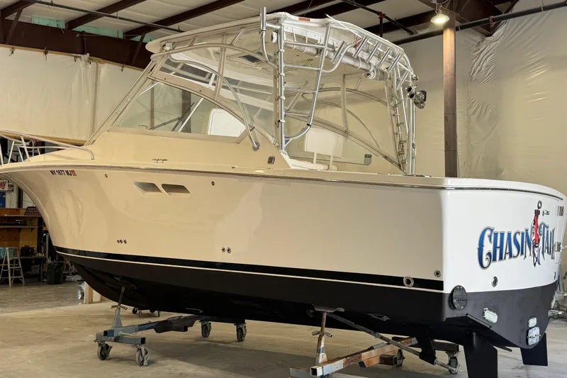 Chasin Tail Yacht Photos Pics 2011 Luhrs 30 Open boat in a warehouse, elevated on stands.