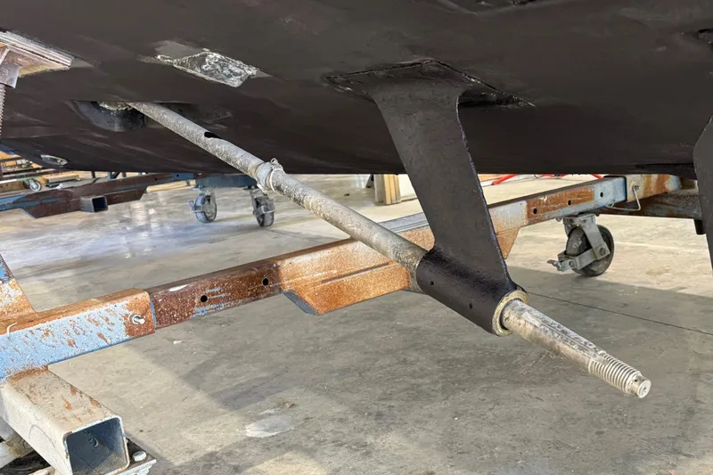 Chasin Tail Yacht Photos Pics Underside view of 2011 Luhrs 30 Open boat on a trailer in a workshop.