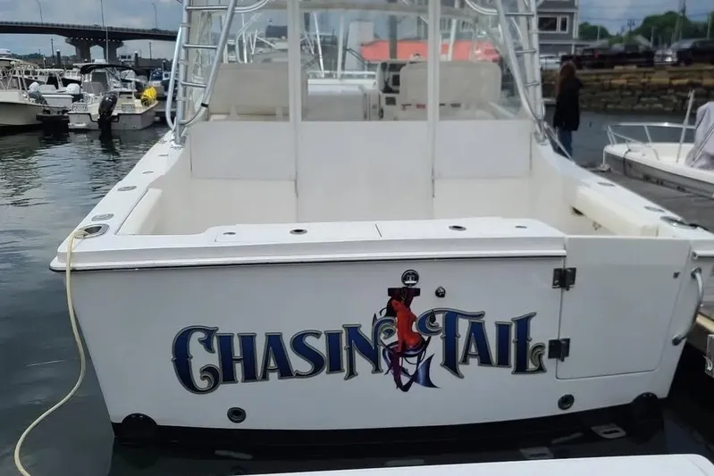 Chasin Tail Yacht Photos Pics 2011 Luhrs 30 Open boat named "Chasin Tail" docked in a marina.