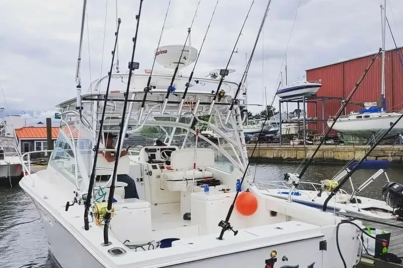 Chasin Tail Yacht Photos Pics 2011 Luhrs 30 Open fishing boat docked with multiple fishing rods.