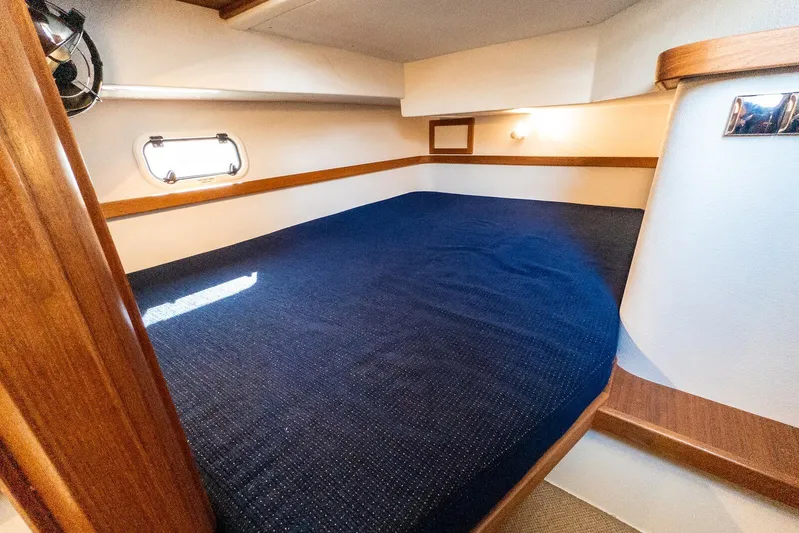 Yacht Photos Pics Cozy cabin interior of 2019 Targa 32 boat with blue bedding and wooden accents.