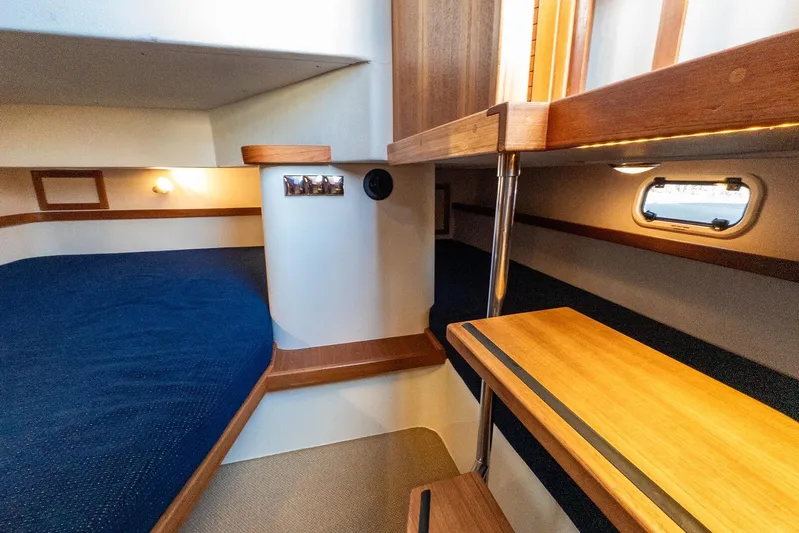  Yacht Photos Pics 2019 Targa 32 boat interior with wooden accents and cozy sleeping area.