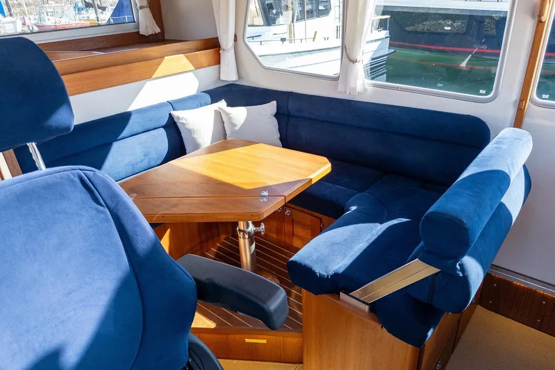  Yacht Photos Pics Interior of 2019 Targa 32 boat with blue seating and wooden table.
