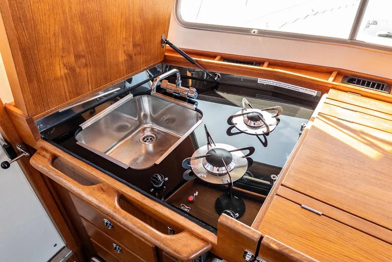  Yacht Photos Pics 2019 Targa 32 boat kitchen with stainless steel sink and dual-burner stove.