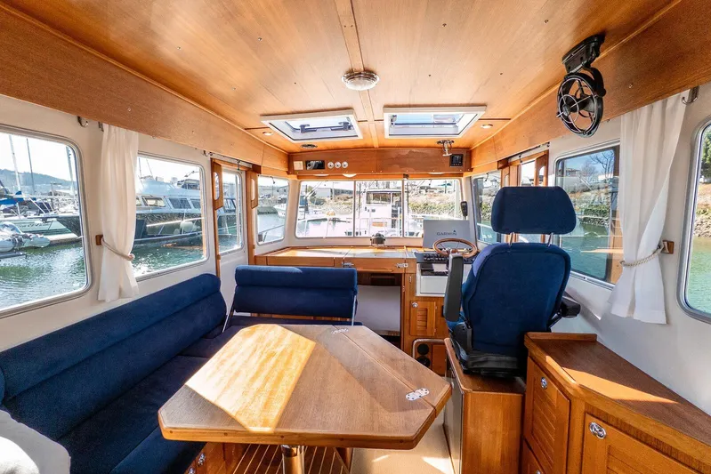  Yacht Photos Pics Interior of 2019 Targa 32 boat with wooden furnishings and blue seating.