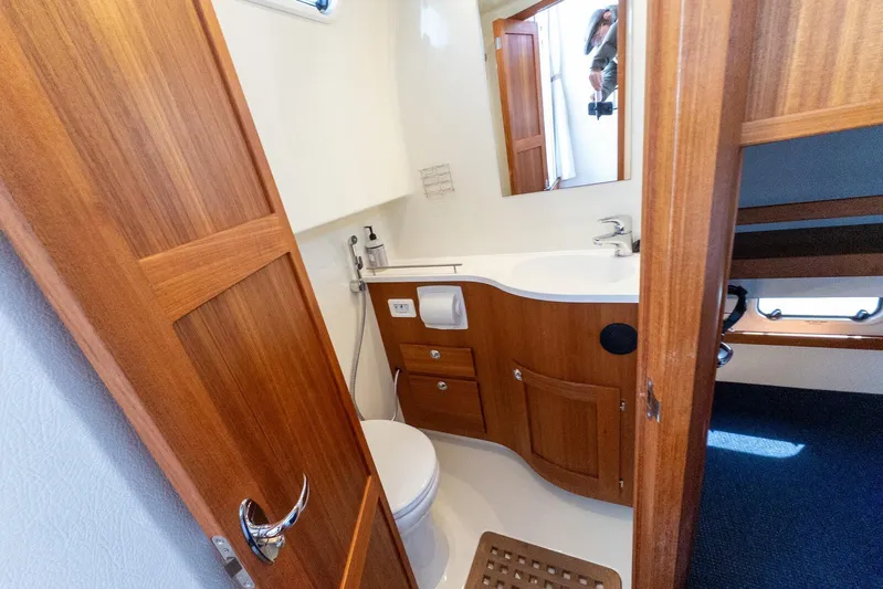  Yacht Photos Pics 2019 Targa 32 yacht bathroom with wooden cabinetry and modern fixtures.