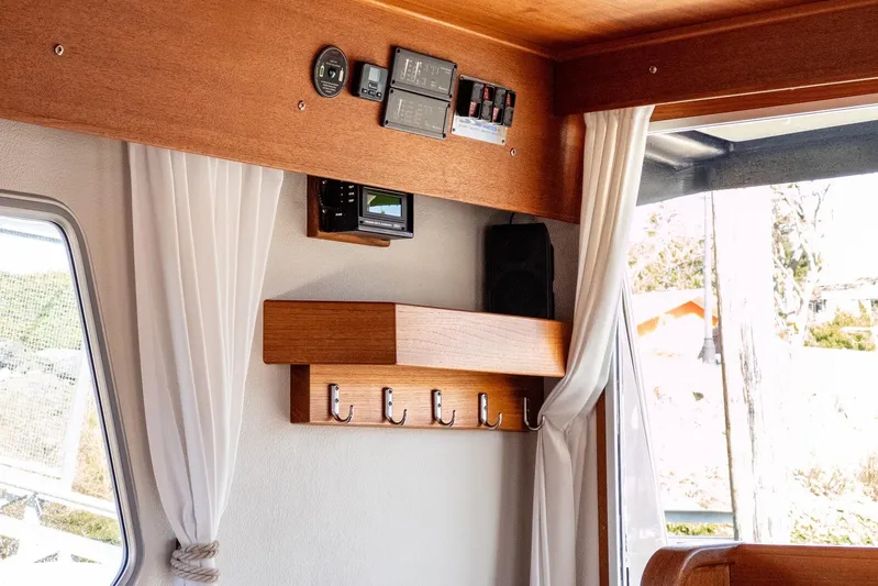  Yacht Photos Pics Interior of 2019 Targa 32 boat with wooden paneling and hooks.