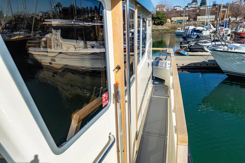  Yacht Photos Pics 2019 Targa 32 boat docked at marina, reflecting water and nearby vessels.
