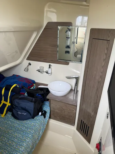  Yacht Photos Pics Interior of 2020 Chris-Craft Catalina 30 with sink, mirror, and storage.