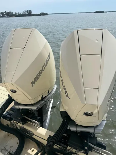  Yacht Photos Pics Twin Mercury outboard engines on a 2020 Chris-Craft Catalina 30, overlooking serene waters.