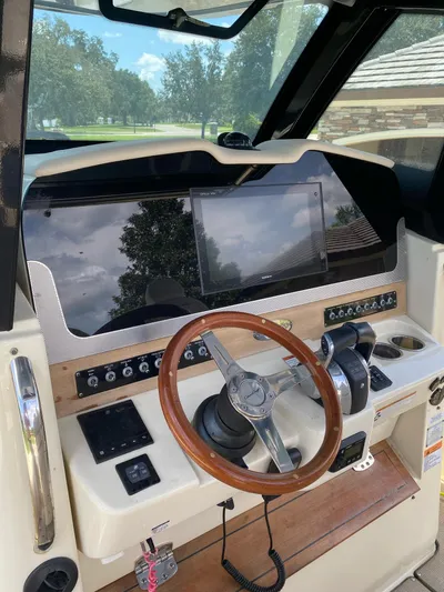  Yacht Photos Pics 2020 Chris-Craft Catalina 30 helm with wooden steering wheel and modern controls.