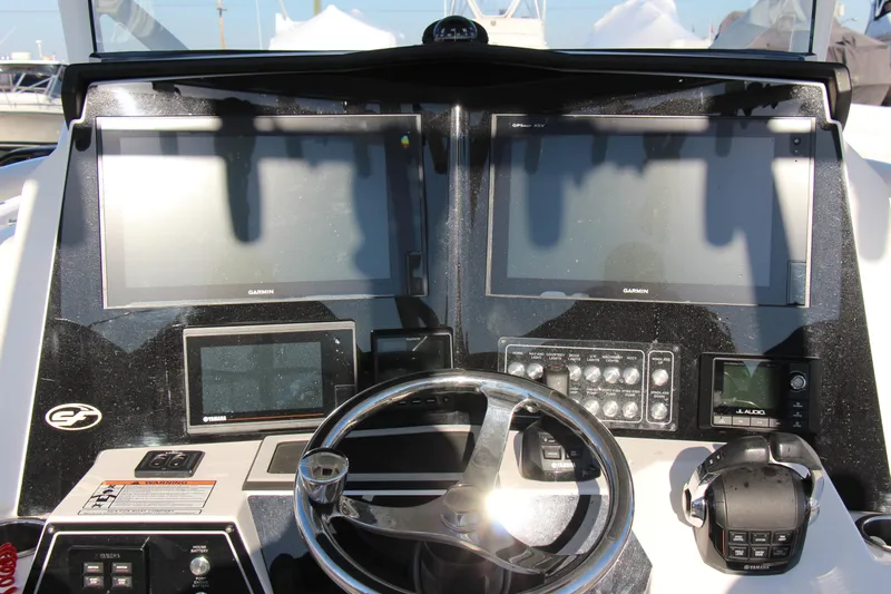 III Yacht Photos Pics Control panel of 2020 Sea Fox 328 Commander boat with Garmin displays and steering wheel.