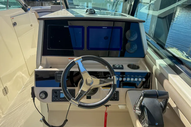  Yacht Photos Pics 2025 Boston Whaler 330 Vantage helm with modern instruments.