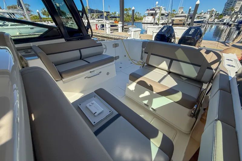  Yacht Photos Pics Interior of 2025 Boston Whaler 330 Vantage with seating area at marina.