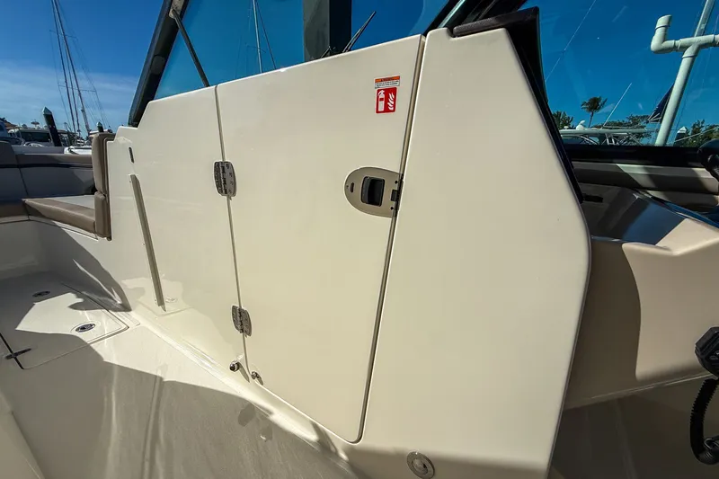  Yacht Photos Pics 2025 Boston Whaler 330 Vantage interior with door and seating area.