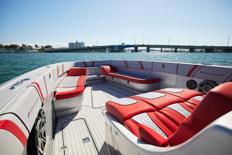 Yacht Photos Pics 2017 Midnight Express 43' Open boat with red and white seating, on calm water near a bridge.