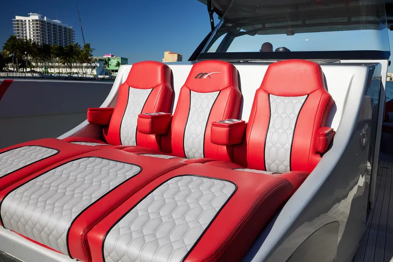  Yacht Photos Pics Red and white seating on 2017 Midnight Express 43' Open boat, docked with cityscape background.