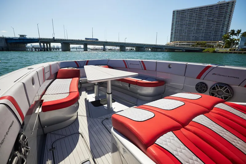  Yacht Photos Pics 2017 Midnight Express 43' Open boat with red seating, docked near a bridge and waterfront building.