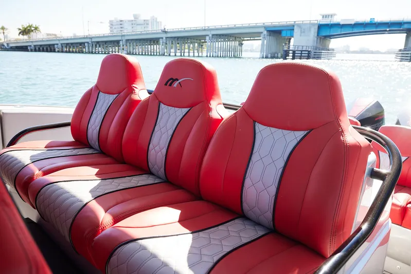  Yacht Photos Pics Red and gray seating on 2017 Midnight Express 43' Open boat, with bridge in background.