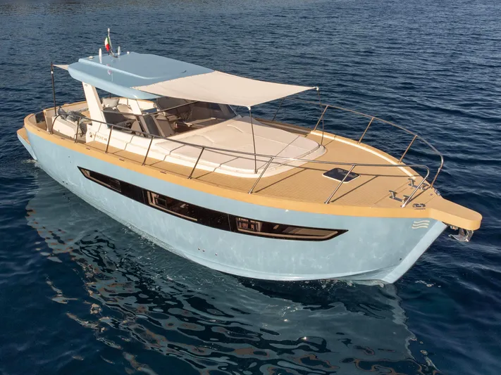  Yacht Photos Pics 2024 Patrone 45 OPEN yacht on calm blue water, featuring sleek design and spacious deck.