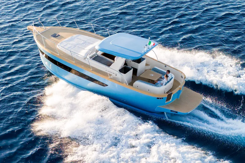  Yacht Photos Pics 2024 Patrone 45 OPEN yacht cruising on open sea, showcasing sleek design and luxury.