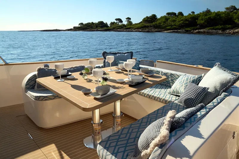  Yacht Photos Pics Luxurious dining setup on a 2024 Patrone 45 OPEN yacht, with ocean view.