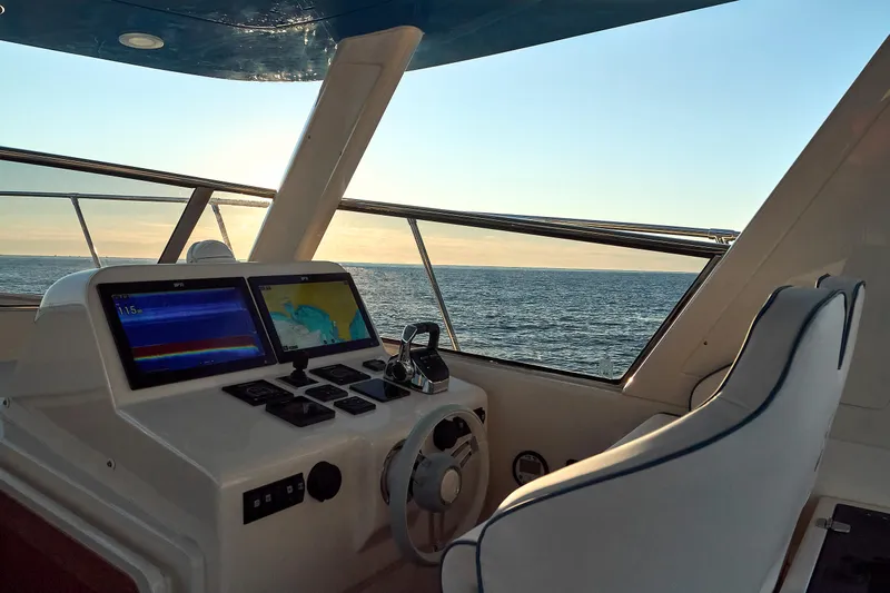  Yacht Photos Pics Helm of 2024 Patrone 45 OPEN yacht with ocean view at sunset.