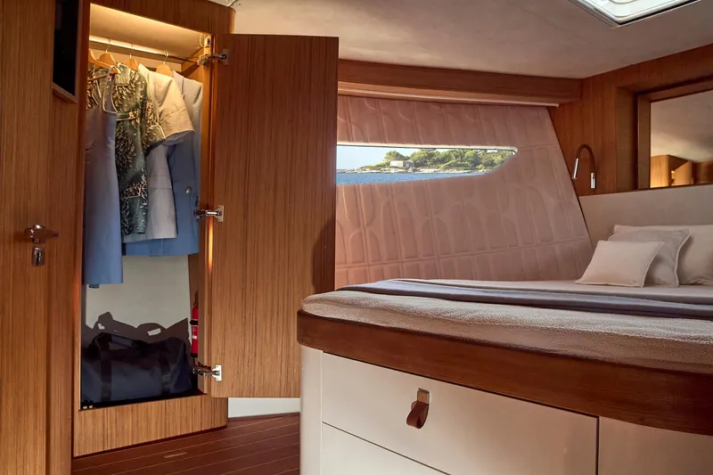  Yacht Photos Pics Luxurious cabin interior of 2024 Patrone 45 OPEN yacht with wardrobe and bed.