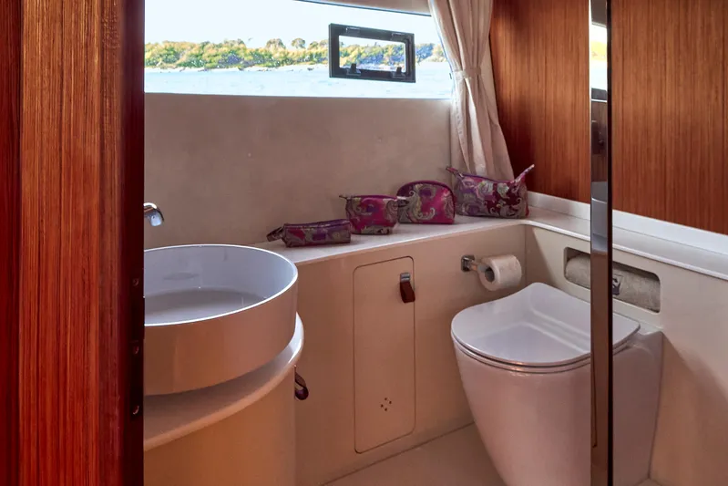  Yacht Photos Pics Luxurious bathroom in 2024 Patrone 45 OPEN yacht with modern fixtures and scenic window view.