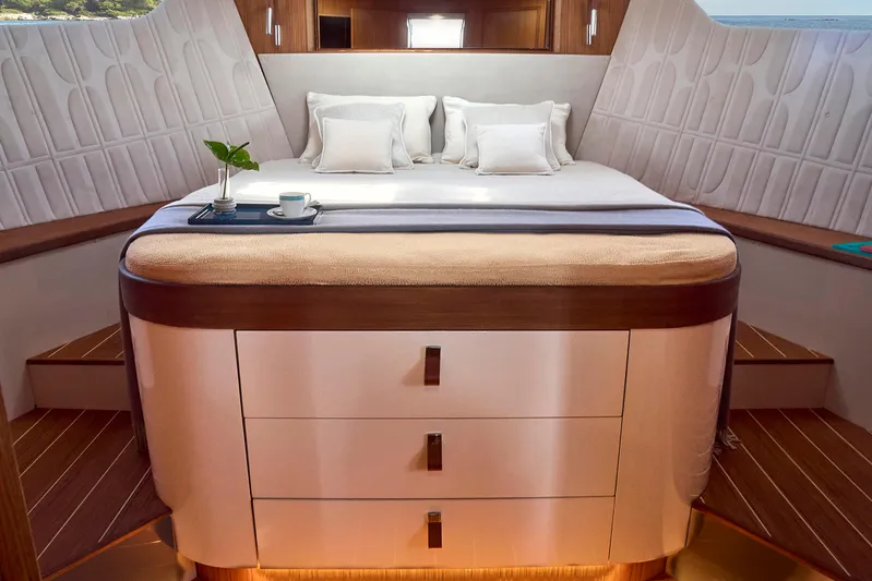  Yacht Photos Pics Luxurious cabin interior of 2024 Patrone 45 OPEN yacht with elegant bedding and wooden accents.