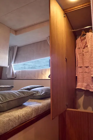  Yacht Photos Pics Interior of 2024 Patrone 45 OPEN yacht with cozy bedding and wooden wardrobe.