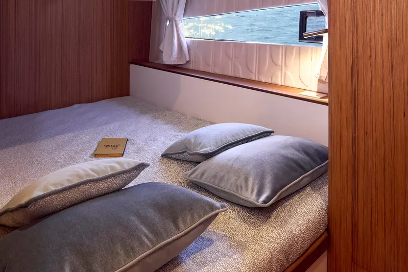  Yacht Photos Pics Cozy cabin interior of 2024 Patrone 45 OPEN yacht with pillows and window view.