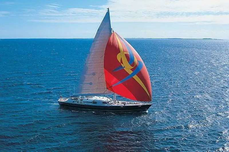  Yacht Photos Pics Sailing yacht Pendennis 155 (2004) with vibrant red sail on open ocean.