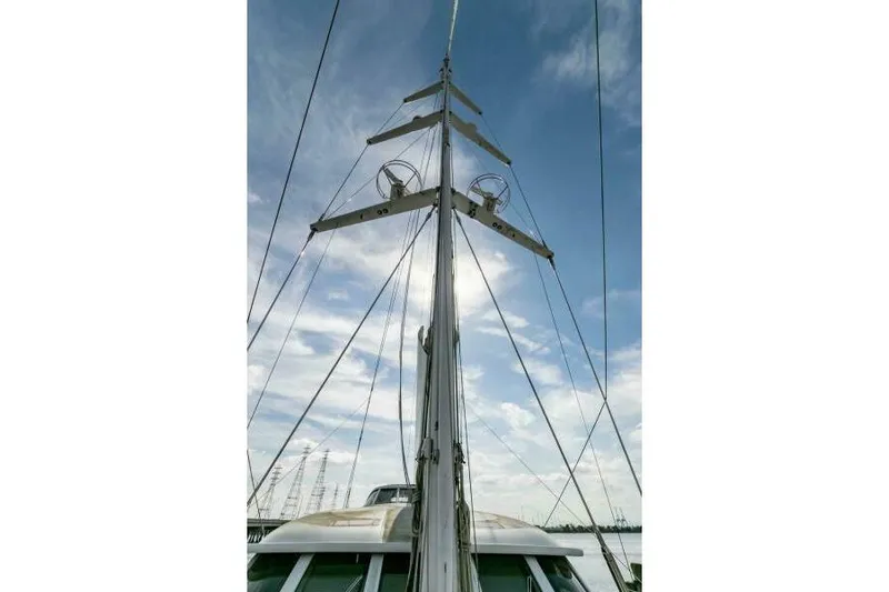  Yacht Photos Pics Mast of Pendennis 155 yacht, 2004 model, against a cloudy blue sky.