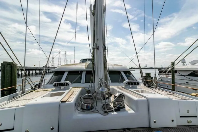  Yacht Photos Pics Luxury Pendennis 155 yacht deck view, 2004 model, docked with clear sky background.