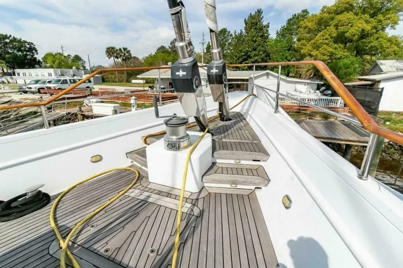  Yacht Photos Pics Deck view of 2004 Pendennis 155 yacht with wooden railings and equipment.